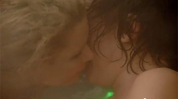 Two people kissing underwater.