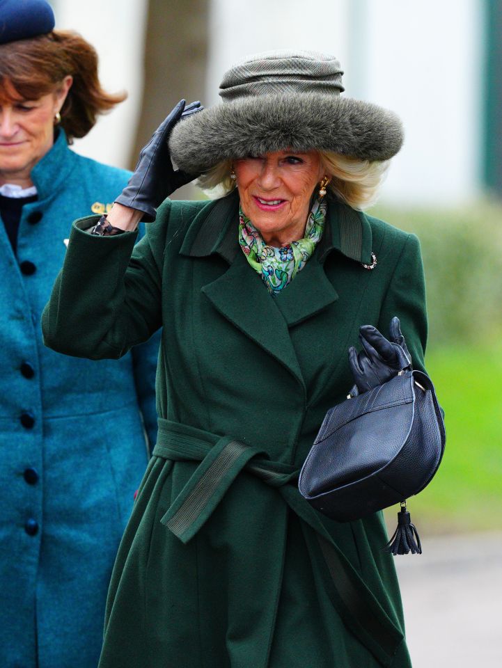 Queen Camilla has arrived for day two of the Cheltenham Festival and looks stylish in green