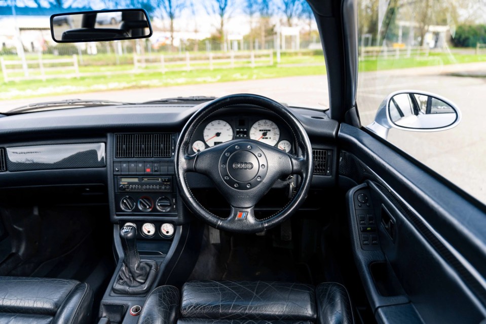 Its stunning interior includes black leather racing seats