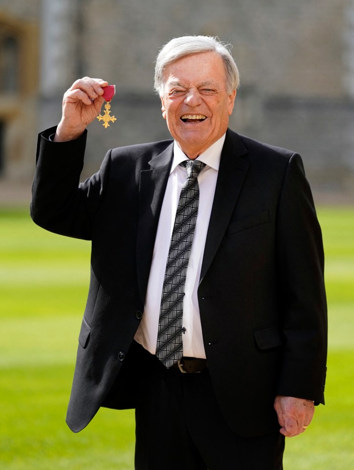Tony posing with his medal after being appointed an Officer of the Order of the British Empire (OBE)