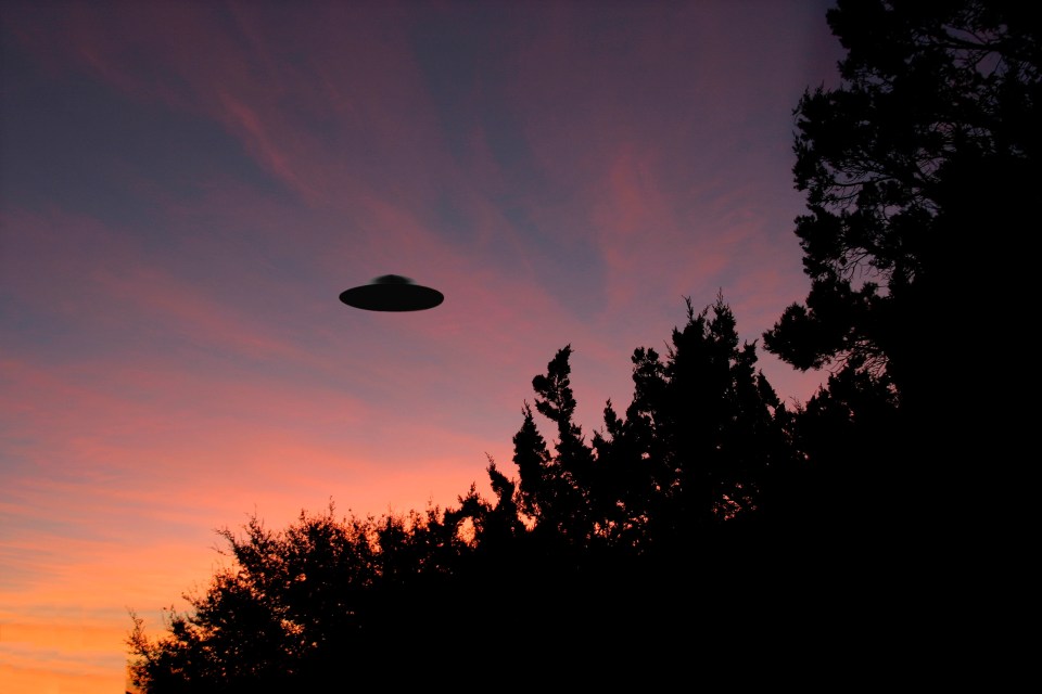 A CGI image of a UFO at sunrise