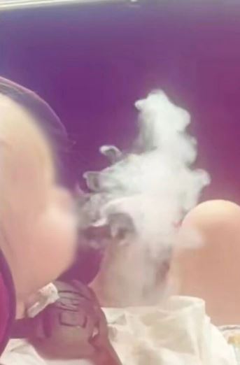 As the tot was engulfed in vapour, a child sitting next to it suffered a coughing fit
