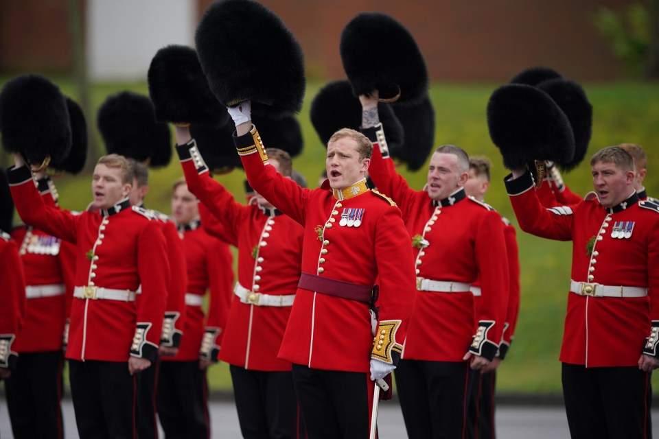 The regiment gave a three cheers to absent Kate as they thrust their bearskins into the air in a mark of respect
