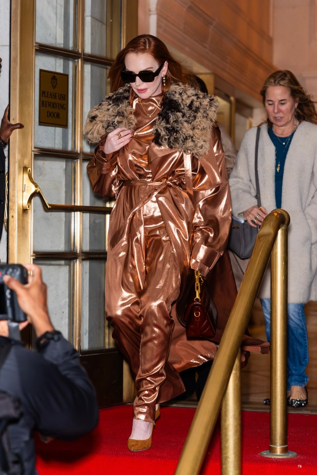 Lindsay Lohan wore this bronze jacket with a shaggy fur collar and trousers as she headed out in New York