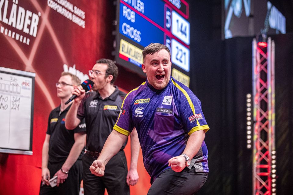 Luke Littler celebrates winning a European Darts Tour championship.