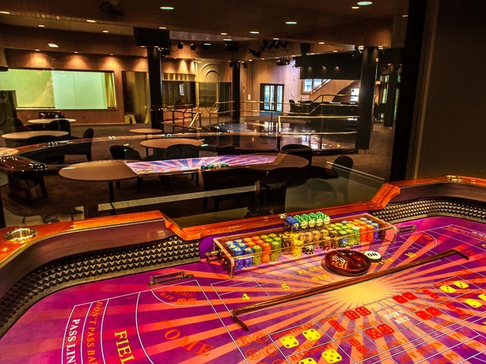 a roulette table with a purple table cloth that says pass line