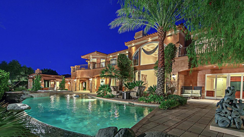 a large house with a swimming pool in front of it