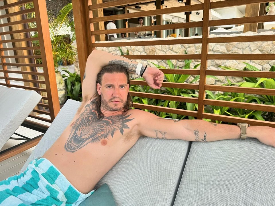 a man with a tattoo on his arm that says love