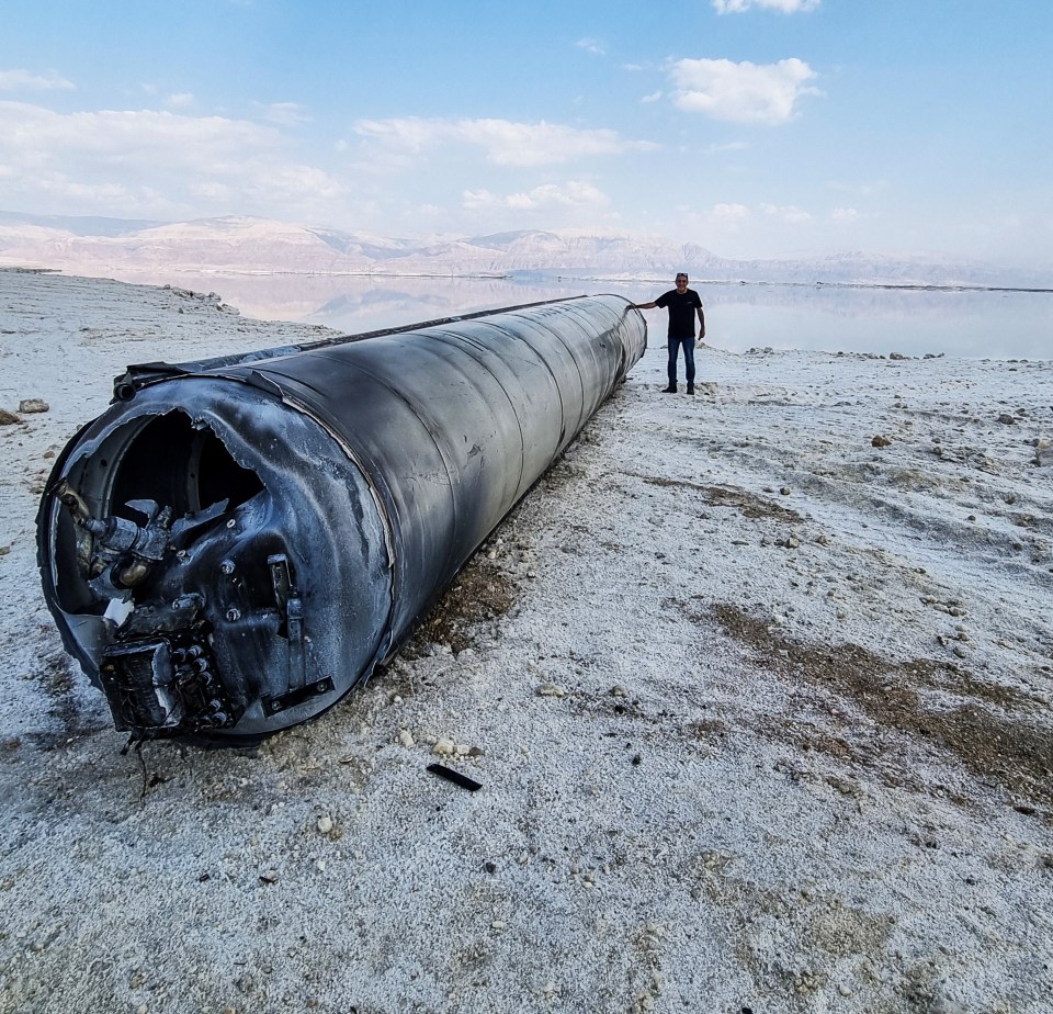 A down Iranian ballistic missile lies on the shore of the Dead Sea