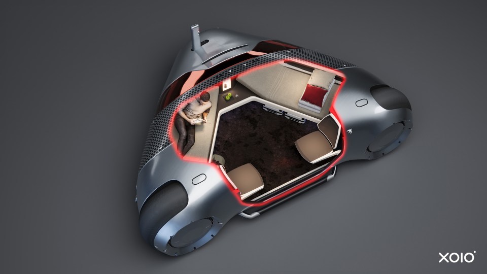 The car's design boasts a luxurious, low-sitting cabin that is attached to three giant wheels