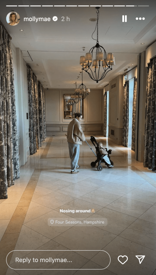 a woman pushing a stroller in a hallway with a reply to mollymae at the bottom