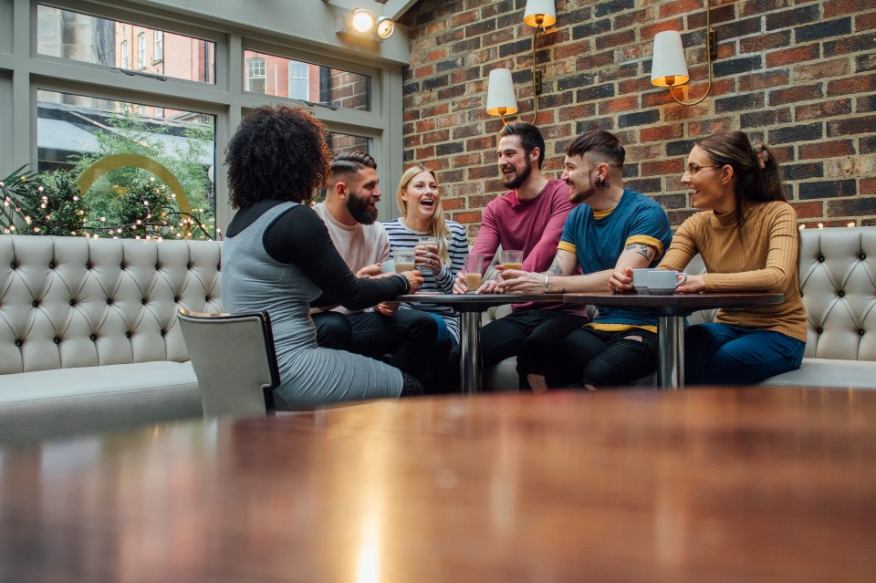 Group of friends are socialising over coffee in a bar/restaurant.