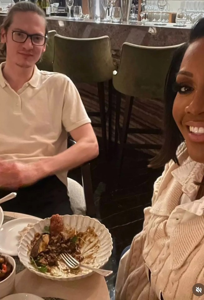 a man and a woman are sitting at a table with plates of food