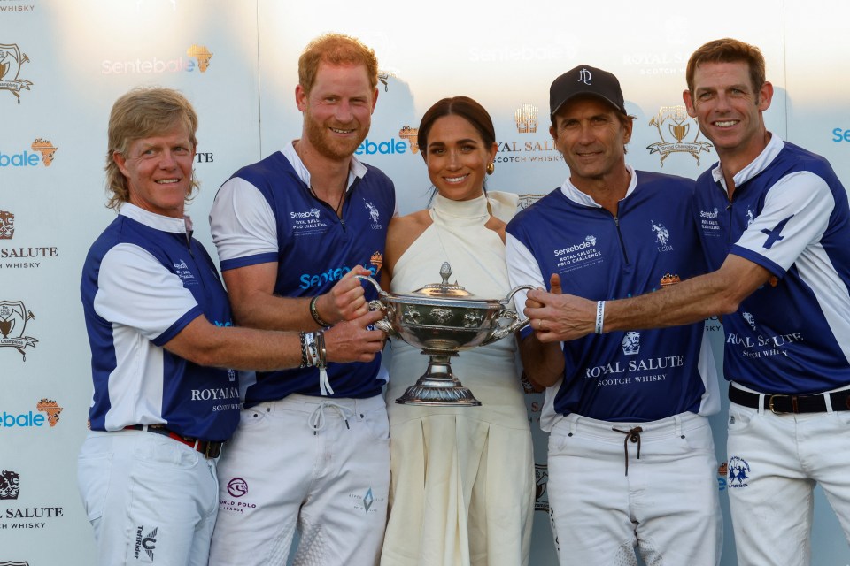 The Sussexes posed with other players as they held their trophy