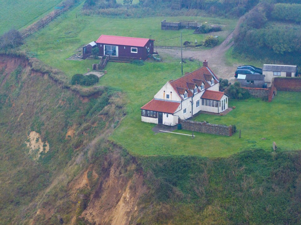 An image from October 2023 shows several metres between the home and the cliff edge