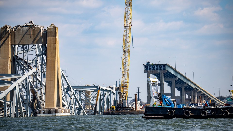 A crane started removing the wreckage of the Francis Scott Key Bridge