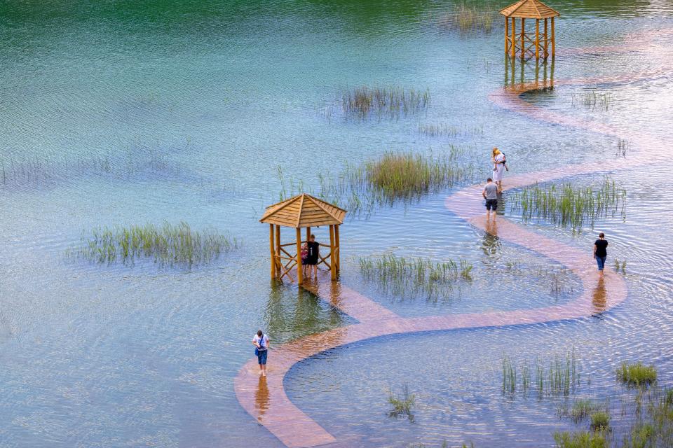 The walkways and small pagodas lead through the water in the lake