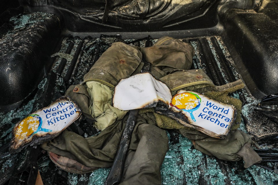 Clothes of members of the World Central Kitchen are seen inside their destroyed car along Al Rashid road