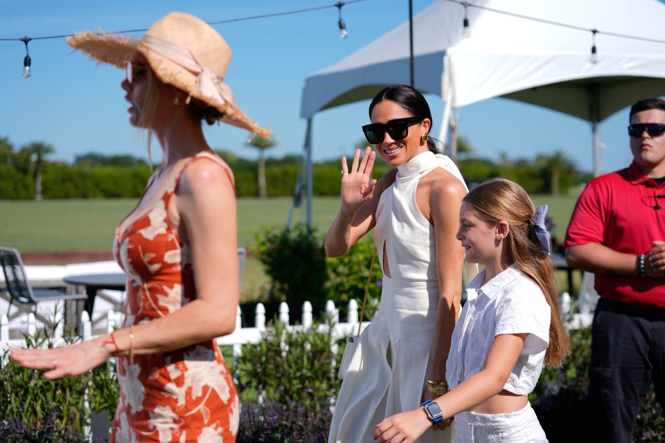 Meghan waved to the cameras as she walked with Delfina Blaquier