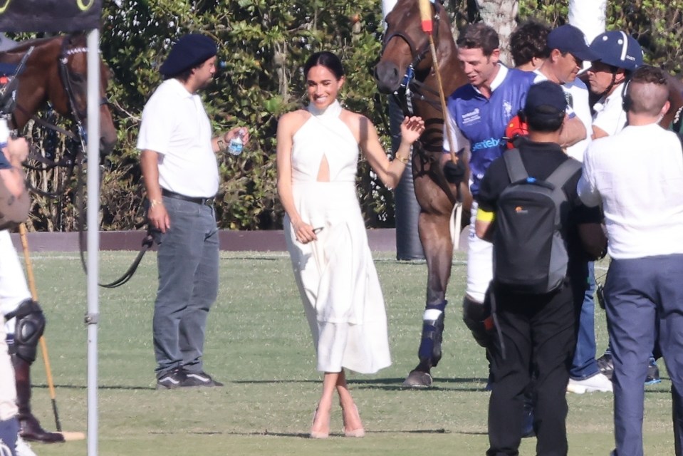 Meghan beamed as the polo players returned from the field