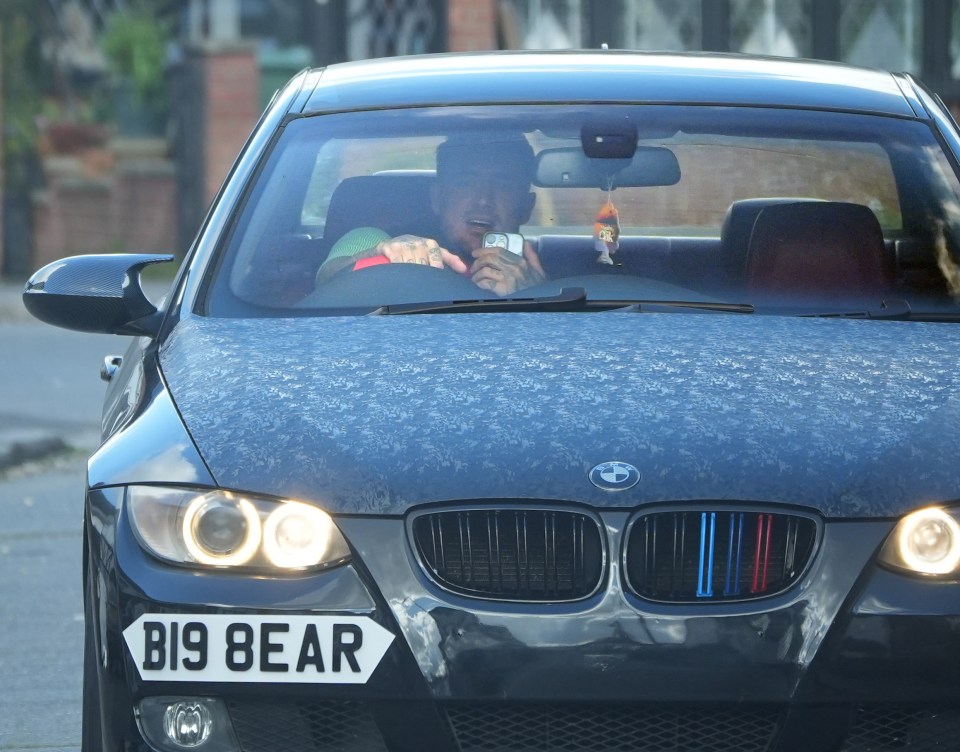 Stephen Bear pictured holding his mobile phone while driving