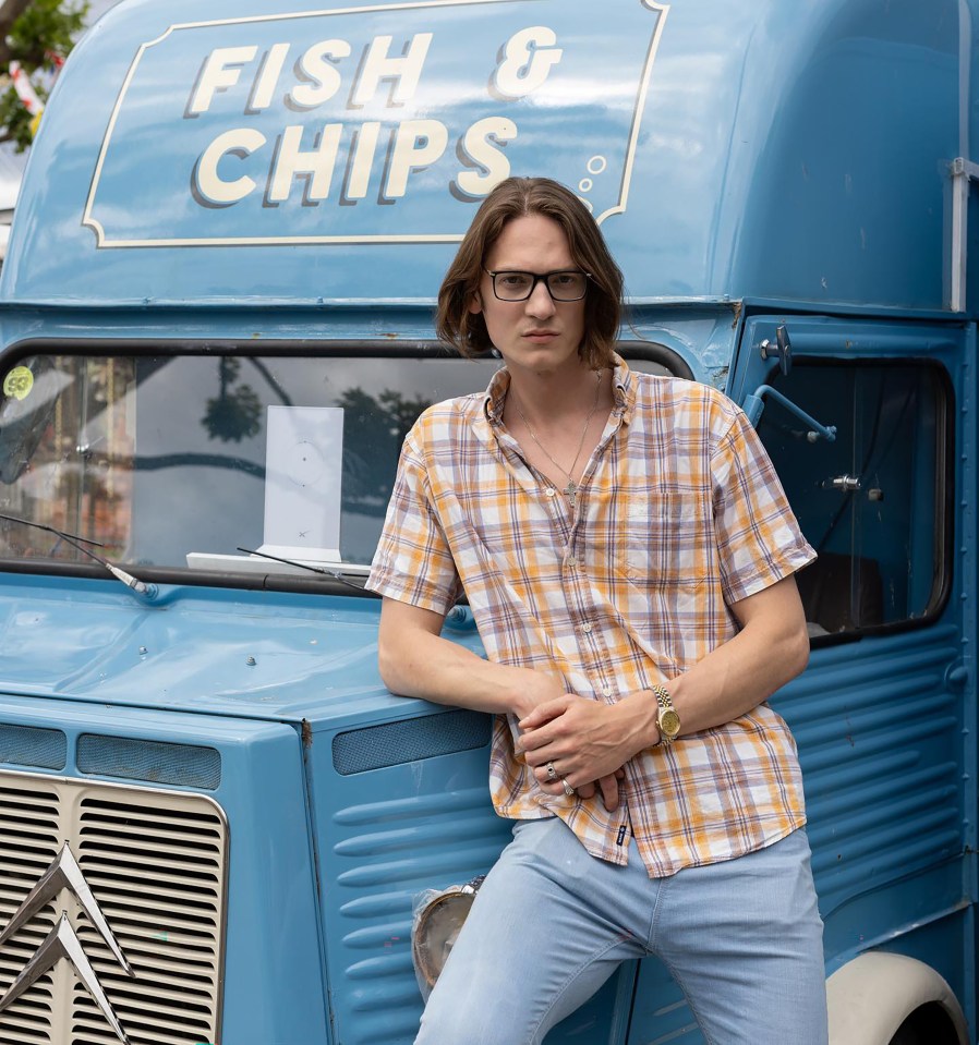 David posing in front of a fish and chips van
