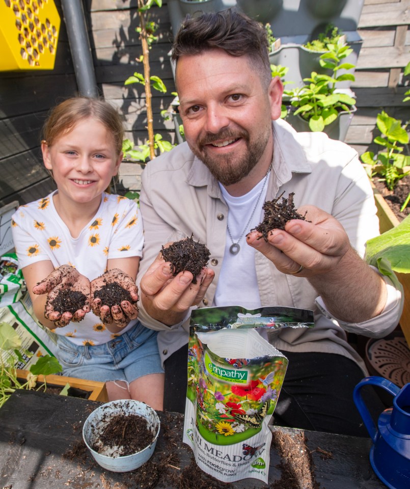 FOR AMY READING and VERONICA LORRAINE - SUN FEATURES..Childrens Gardening Champion Lee Connolly, 36 with daughter Olive, 8 getting ready for National Childrens Gardening Week from May 25th onwards. They are pictured in their garden in Colchester, Essex...Here Lee and Olive are making balls of compost mixed with wild flower seeds. Great fun to get your hands messy!..PICTURE BY JOHN McLELLAN - 19.5.24......