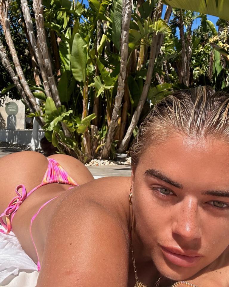 She flashed her bum in the pink two-piece while soaking up the sun