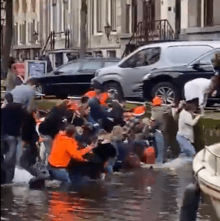 A boat full of party goers in Amsterdam were left desperately scrambling as their boat sunk in a canal