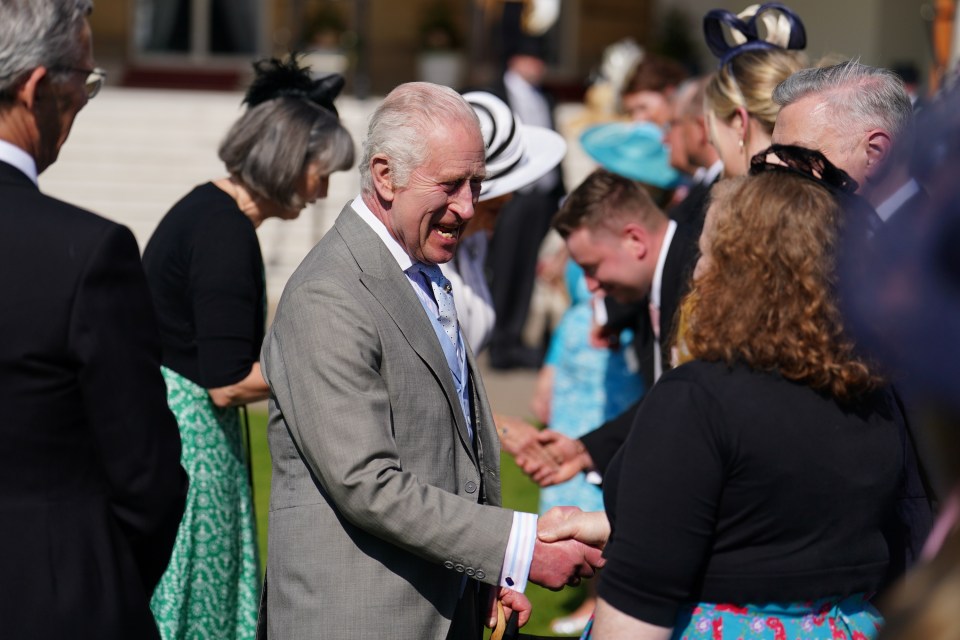 The monarch beamed as he greeted guests