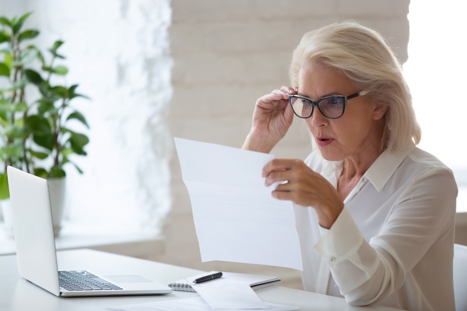 Surprised businesswoman reading a document.