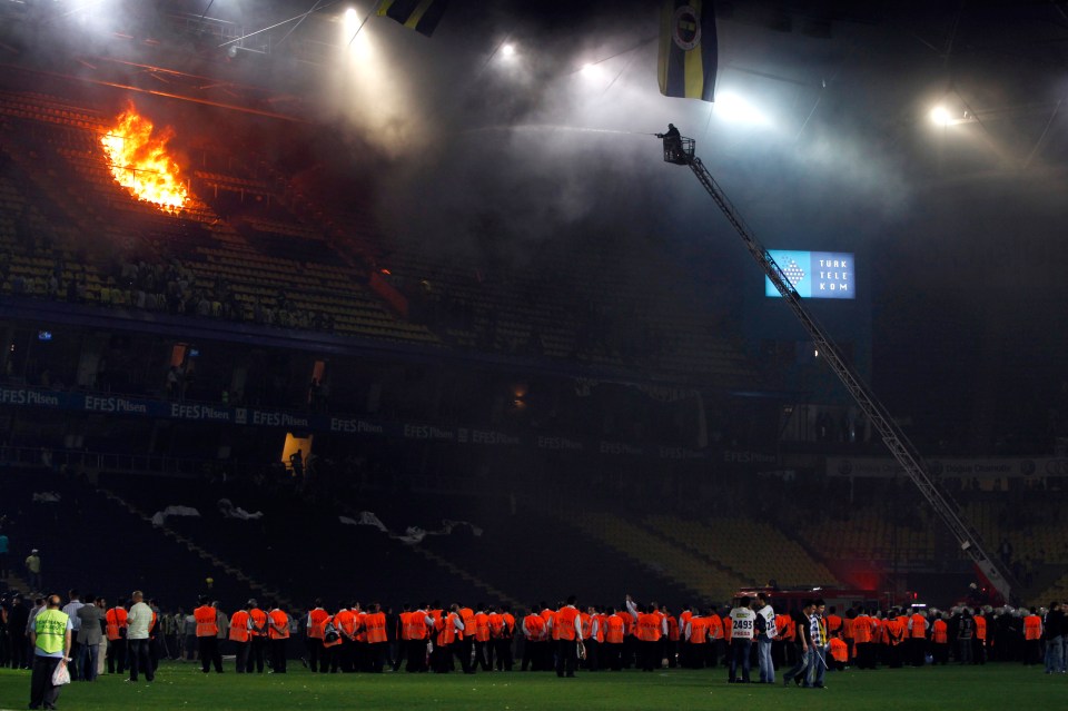 a group of people standing in front of a stadium that has the word efes on it