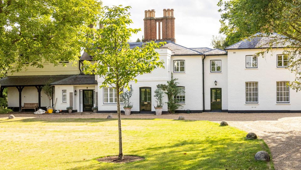 a large white house with a tree in front of it