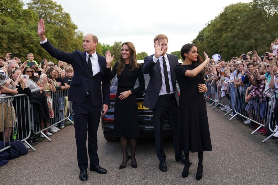 Prince William, Kate Middleton, Prince Harry, and Meghan Markle waving to crowds at Windsor Castle.