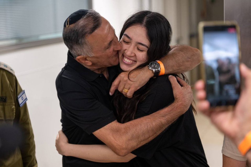 Noa Argamani  smiles as she's hugged by her dad after she was rescued by Israeli special forces