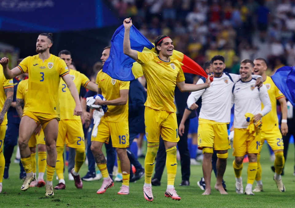 Romania players celebrate their progression to the knockout stages