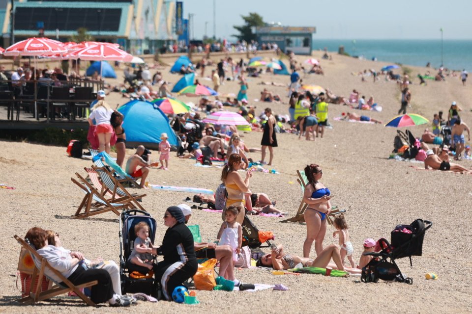 Beachgoers making the most of glorious weather at Thames Estuary in Southend-on-Sea, in Essex today