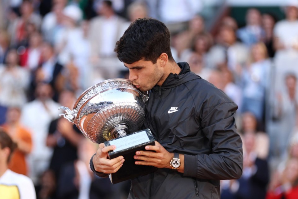 PARIS, FRANCE - JUNE 09: Carlos Alcaraz of Spain kisses the winners trophy after victory in the Men's Singles Final match between Alexander Zverev of Germany and Carlos Alcaraz of Spain on Day 15 of the 2024 French Open at Roland Garros on June 09, 2024 in Paris, France. (Photo by Clive Brunskill/Getty Images)