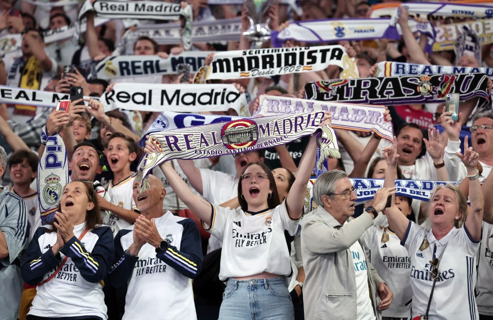 Real Madrid fans celebrate their team's victory as they watch a live broadcast of the UEFA Champions League final football match between Borussia Dortmund and Real Madrid, held in London, at the Santiago Bernabeu stadium in Madrid on June 1, 2024. (Photo by Thomas COEX / AFP) (Photo by THOMAS COEX/AFP via Getty Images)