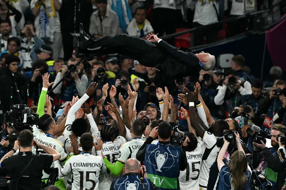 Real Madrid's Italian coach Carlo Ancelotti is thrown in the air by his players as they celebrate after the UEFA Champions League final football match between Borussia Dortmund and Real Madrid, at Wembley stadium, in London, on June 1, 2024. (Photo by Ben Stansall / AFP) (Photo by BEN STANSALL/AFP via Getty Images)