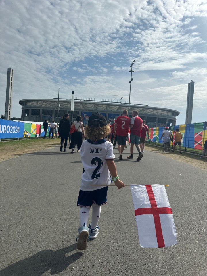 Lauryn walks with her son Kairo towards the stadium where dad Kyle will be playing