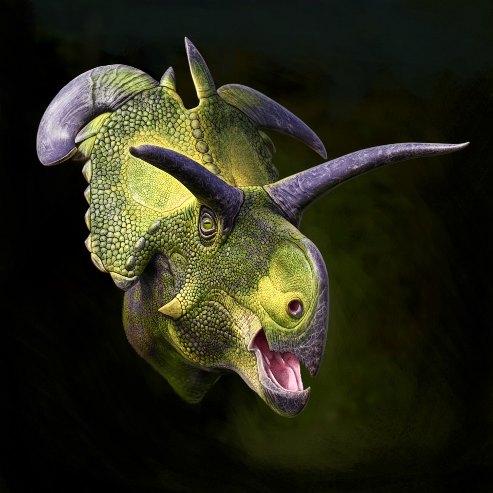 a green and purple dinosaur with its mouth open