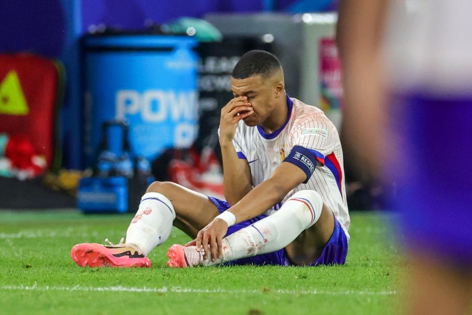 a soccer player with a captain 's armband that says ' uefa ' on it