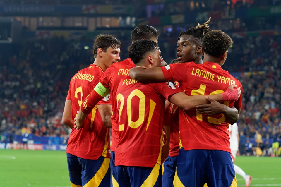 a group of soccer players huddle together with one wearing the number 10