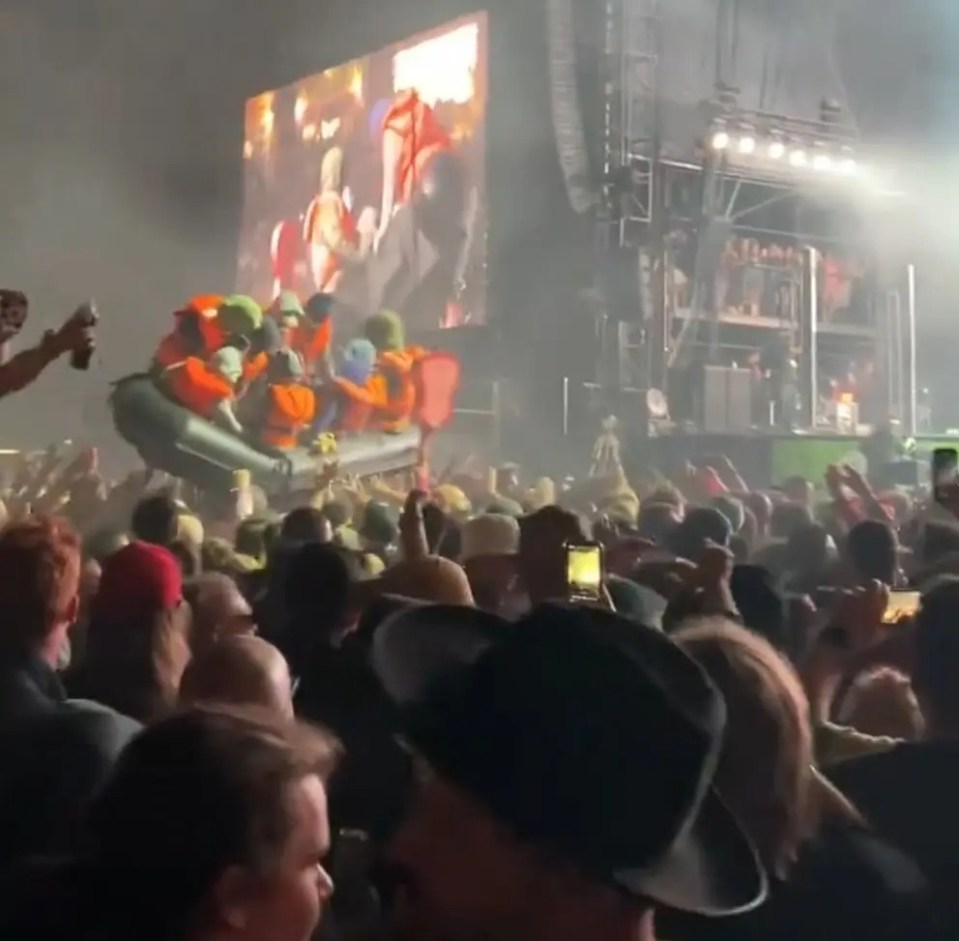 a crowd of people are watching a man in a raft on a stage