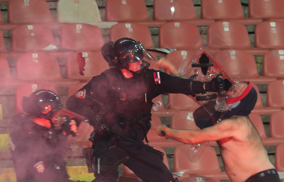 Serbian cops battling against ultra members in the stands