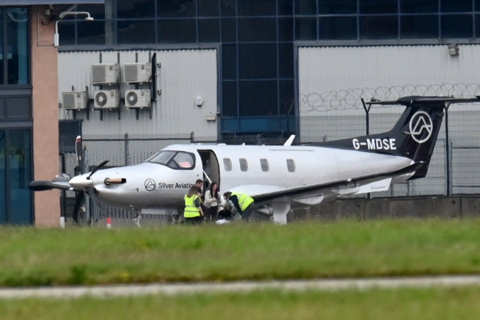 a silver aviation plane is parked on the runway
