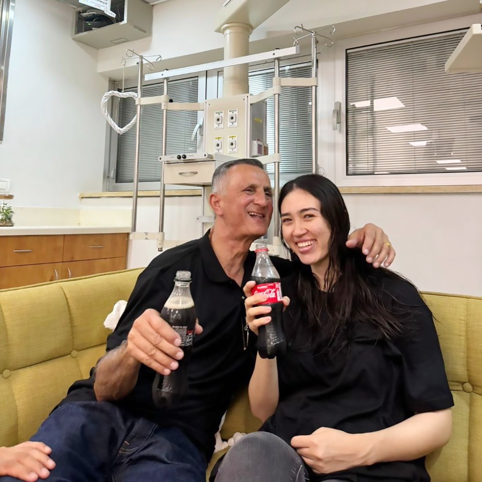 Noa enjoys a coke after being reunited with her dad Yaakov back in Israel following a daring rescue mission on Saturday morning