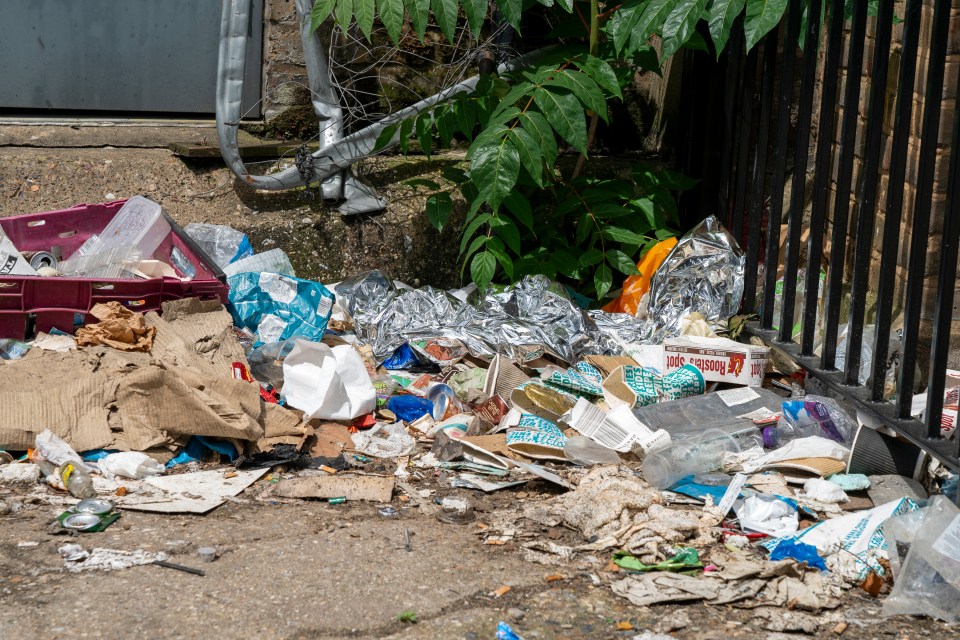a pile of garbage with a container that says ' washing up liquid ' on it