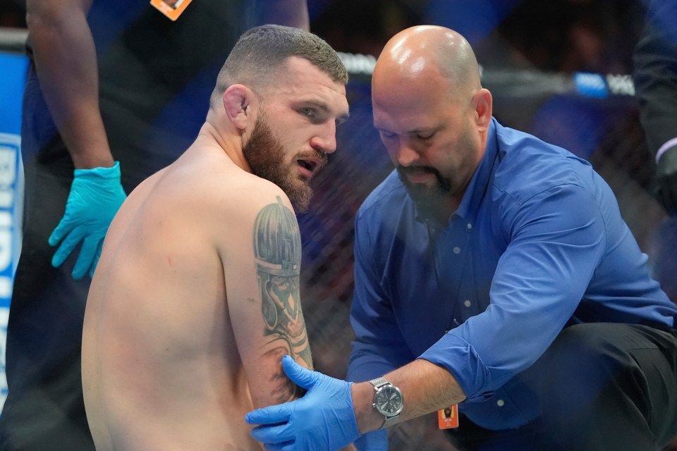 Michael Oleksiejczuk looks on after having his arm badly injured